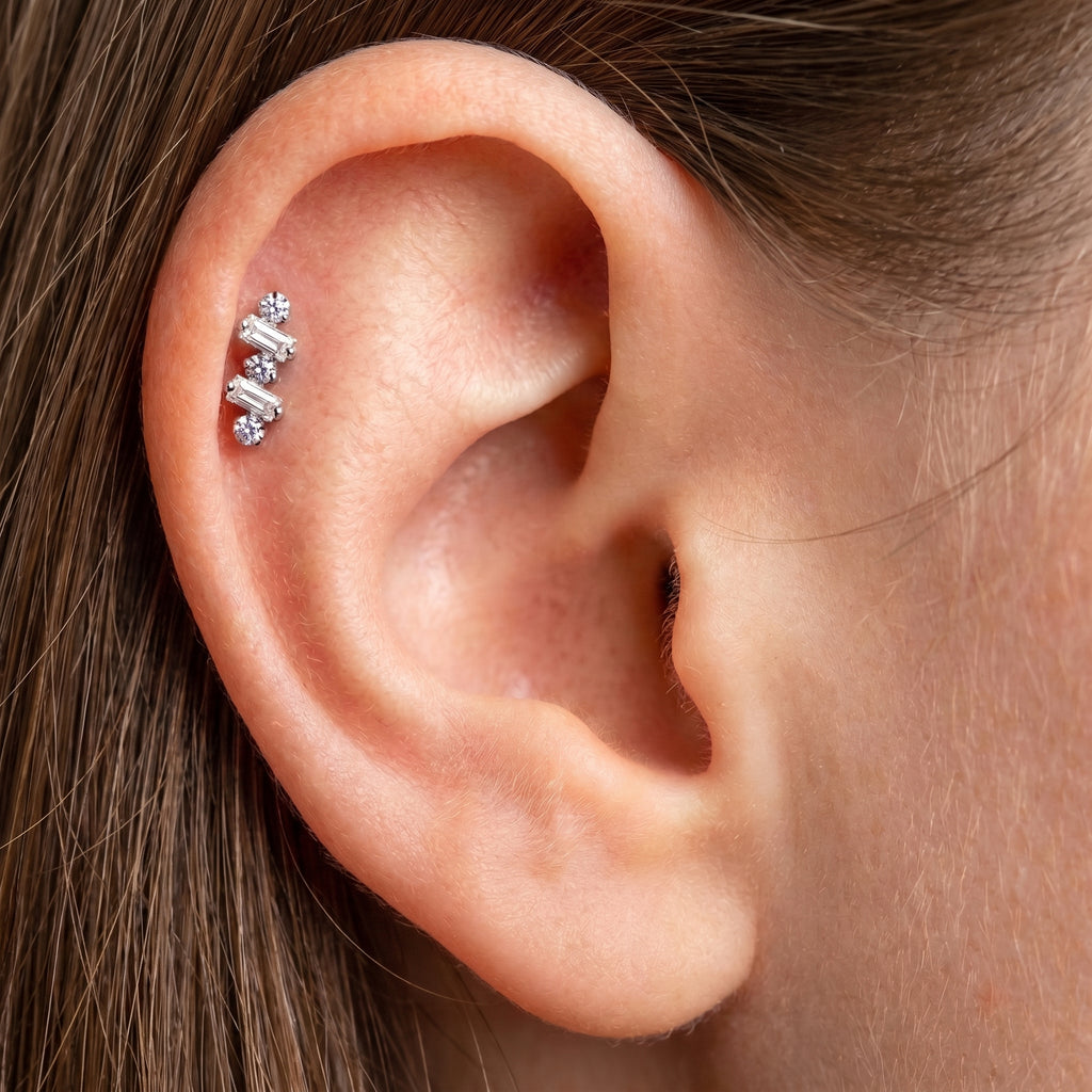Close-up of the baguette-cut CZ crawler setting on the titanium ear climber stud, showing the finish detail