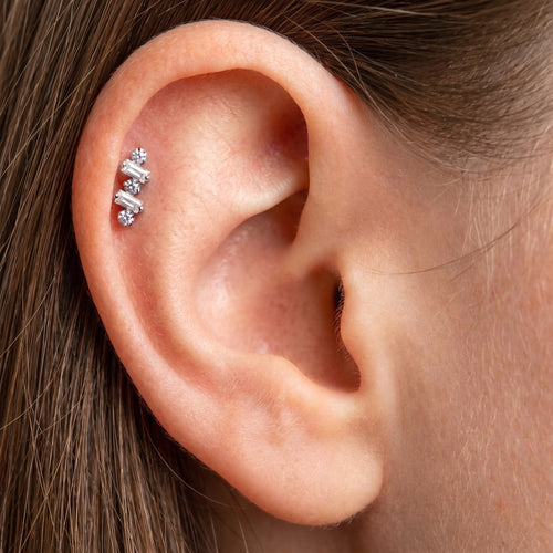 Close-up of the baguette-cut CZ crawler setting on the titanium ear climber stud, showing the finish detail