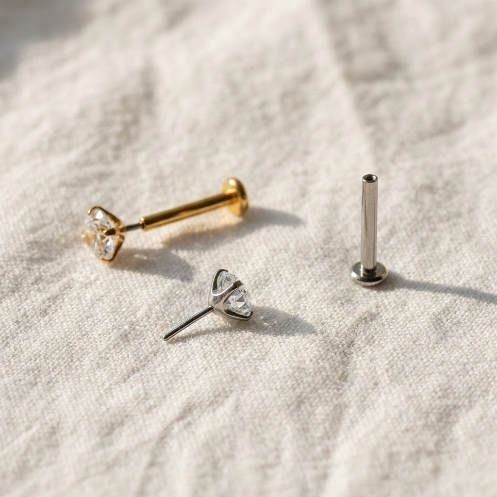 Styled shot of the titanium CZ (cubic zirconia) flat-back labret stud shown for helix, tragus and nostril piercings