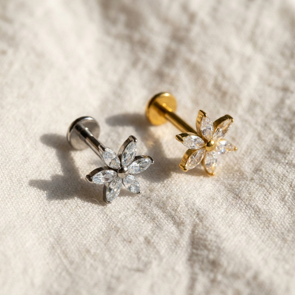 Styled shot of the titanium CZ (cubic zirconia) flat-back labret stud shown for helix, tragus and conch piercings