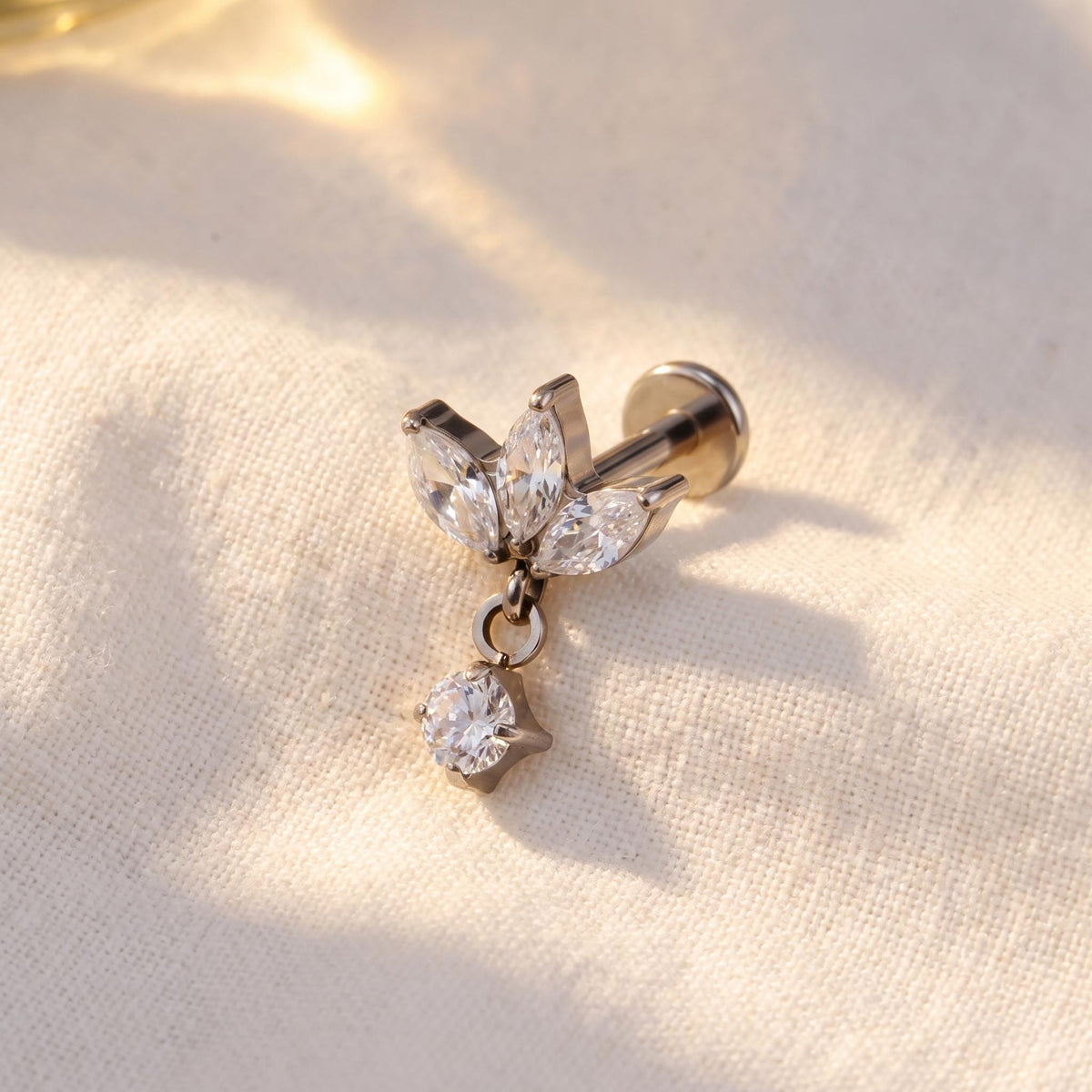 Angled view of the titanium triple marquise CZ stud for helix and tragus piercings