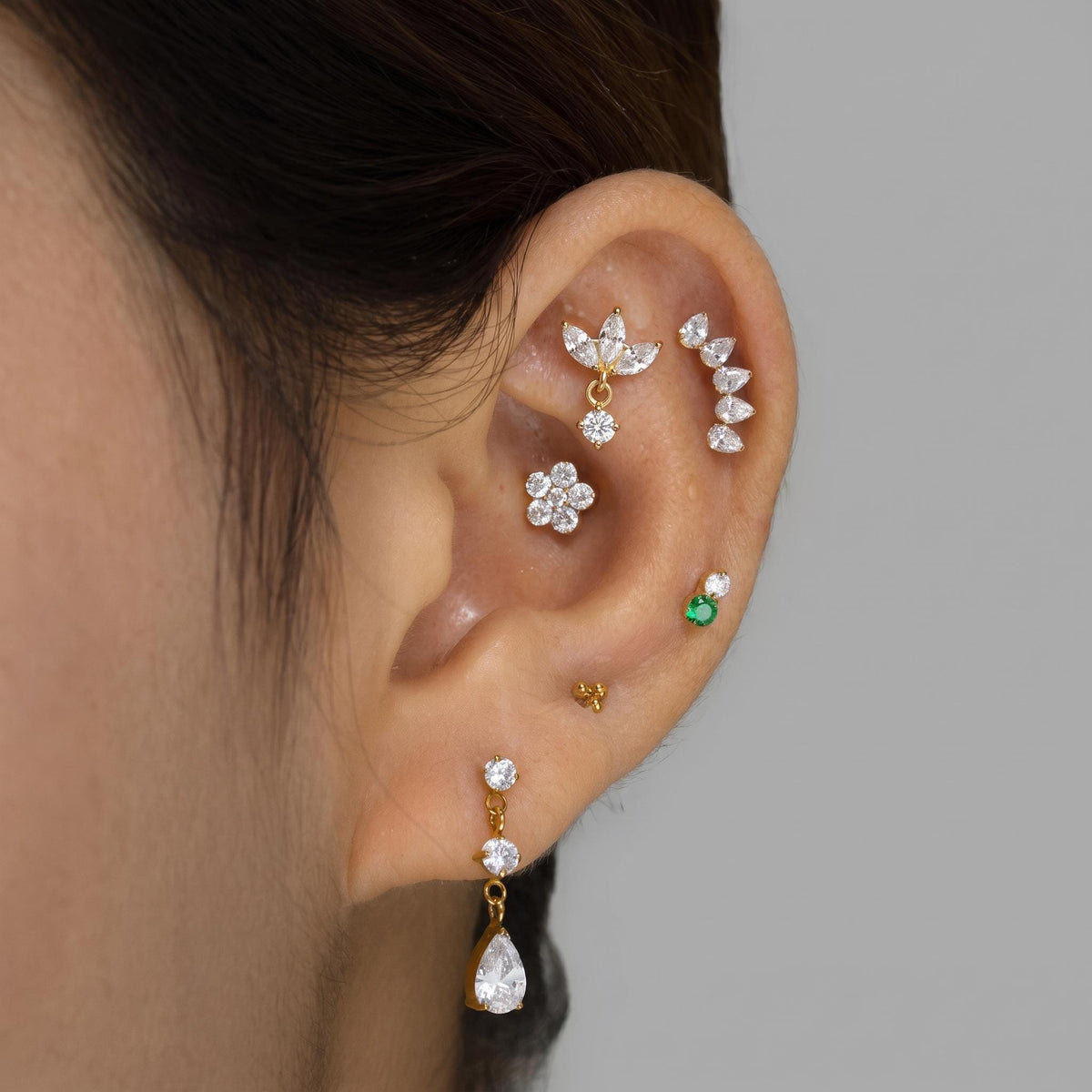 Styled shot of the titanium triple marquise CZ stud shown for helix and cartilage piercings