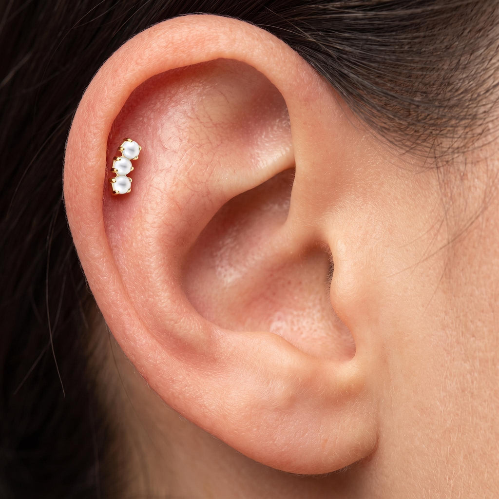 Close-up of the three graduated pearls on the titanium threaded stud, showing the finish detail
