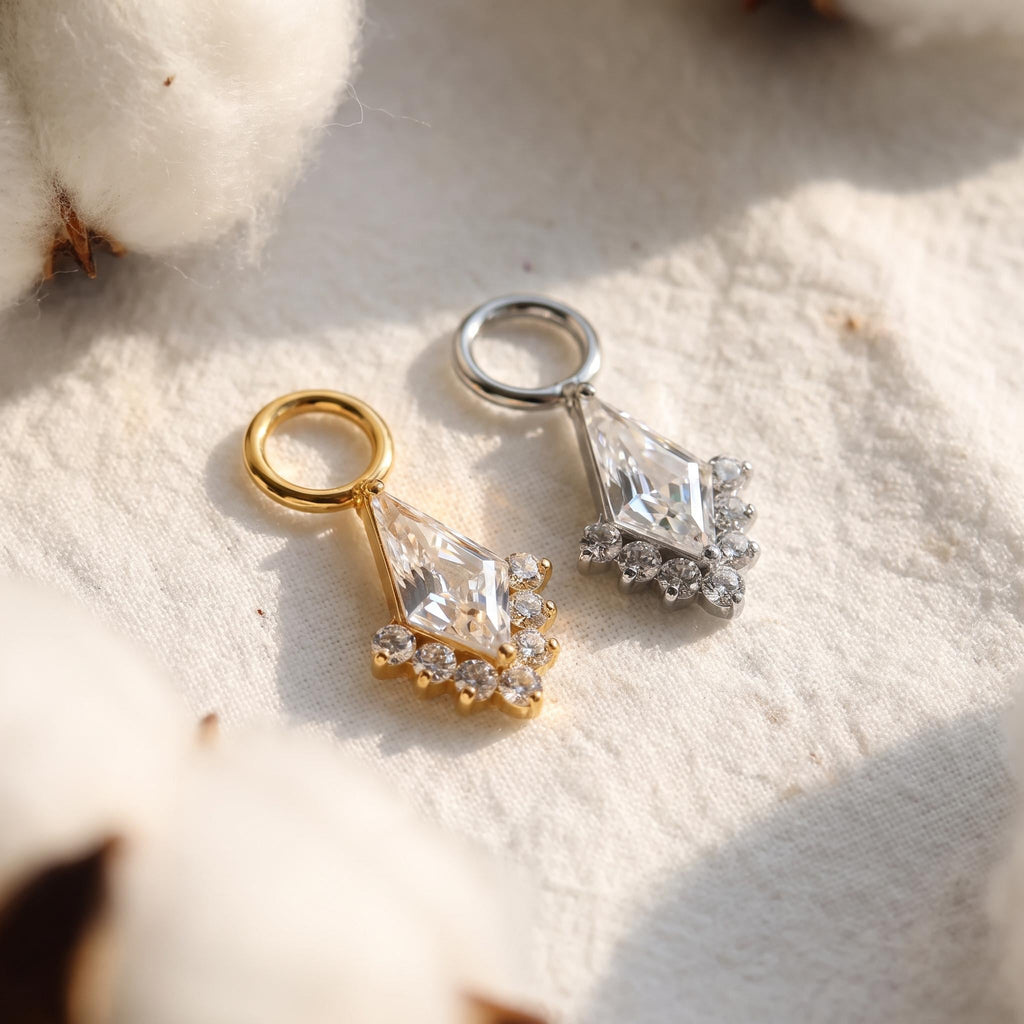 Styled shot of the titanium kite CZ dangle charm shown clipped onto a cartilage clicker