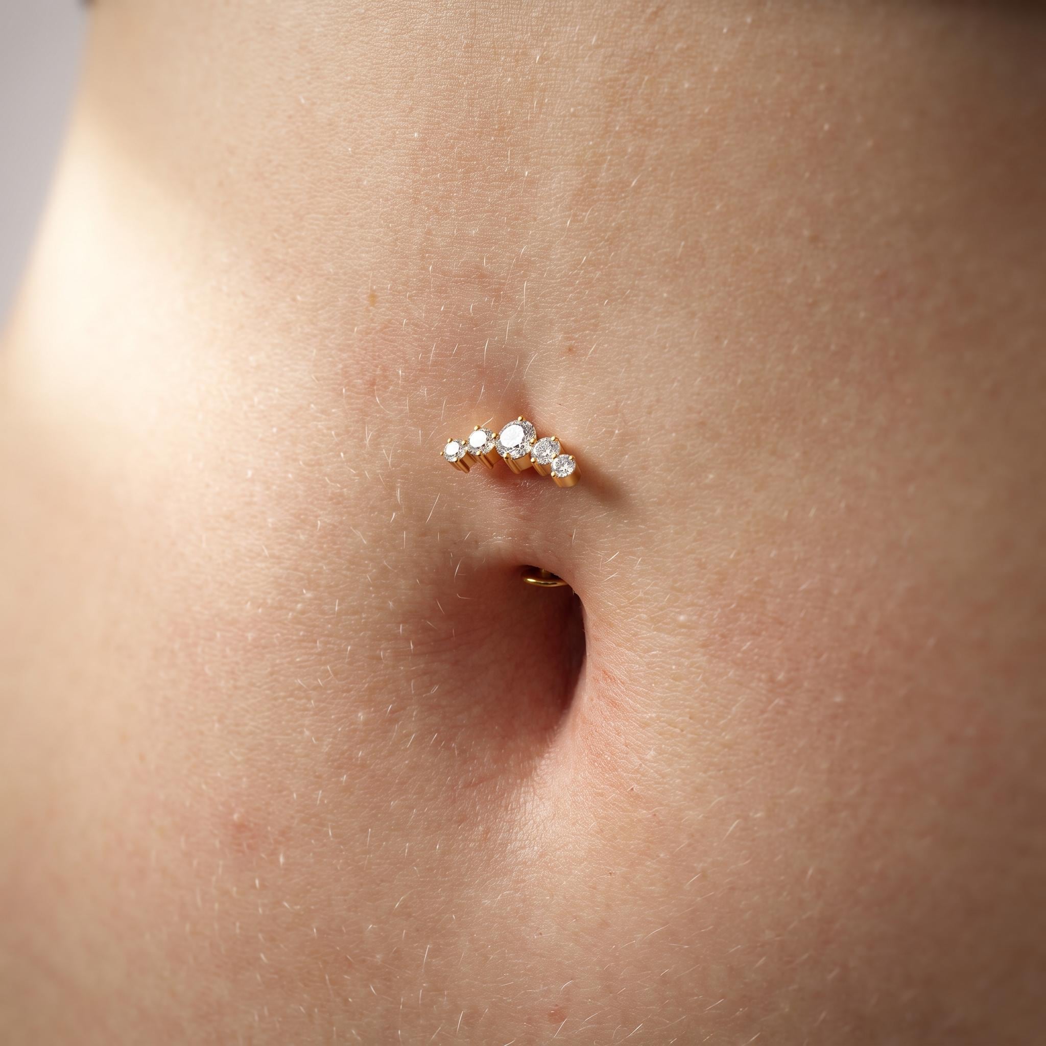 Close-up of the five graduated CZ stones on the titanium flat-bottom navel barbell, showing the finish detail