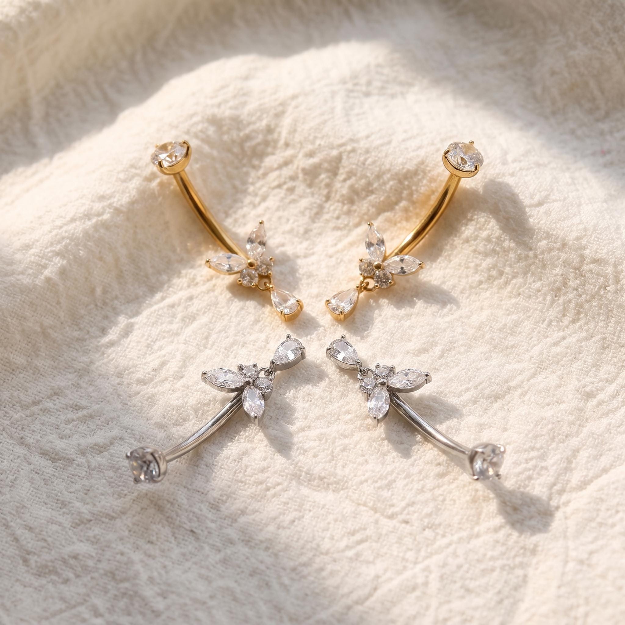 Styled shot of the titanium butterfly dangle belly ring shown for navel piercings